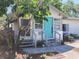 Inviting single-story home with a vibrant blue front door, stone walkway, and beautifully landscaped garden at 415 21St N St, St Petersburg, FL 33713