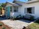 Inviting home with a well-manicured lawn, blue door, and welcoming porch at 415 21St N St, St Petersburg, FL 33713