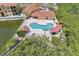 Aerial view of community pool, landscaping, and waterway at 4343 Bayside Village Dr # 104, Tampa, FL 33615