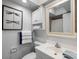 Cozy bathroom featuring white fixtures, cabinetry, and decorative dragonfly art at 4939 Floramar Ter # 501, New Port Richey, FL 34652