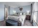 Calm bedroom featuring a comfortable bed, ottoman, and soft lighting at 4939 Floramar Ter # 501, New Port Richey, FL 34652