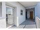 View of condo building entrance hall with white walls, glass door, and elevator access at 4939 Floramar Ter # 501, New Port Richey, FL 34652