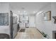 Bright kitchen with stainless steel appliances, white cabinets, and tile flooring, door to corridor at 4939 Floramar Ter # 501, New Port Richey, FL 34652