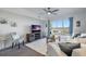 Bright living room featuring comfortable seating, large window with view, and ceiling fan at 4939 Floramar Ter # 501, New Port Richey, FL 34652