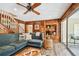 Living room with wood-paneled walls, built-in shelving, and pool view at 6034 17Th N Ave, St Petersburg, FL 33710