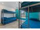Bedroom with teal walls and two bunk beds at 6926 Williams Dr, Tampa, FL 33634