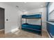 Bedroom with a twin-over-full bunk bed and blue wall at 6926 Williams Dr, Tampa, FL 33634