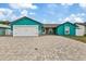 Teal house exterior with paver driveway, 2-car garage, and stone accents at 6926 Williams Dr, Tampa, FL 33634