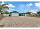 Teal house exterior with paver driveway and 2-car garage at 6926 Williams Dr, Tampa, FL 33634