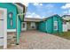 Teal house exterior with paver driveway and stone accents at 6926 Williams Dr, Tampa, FL 33634