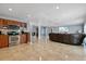 Open kitchen with wood cabinets, stainless steel appliances, and breakfast bar at 6926 Williams Dr, Tampa, FL 33634
