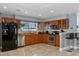 Modern kitchen with wood cabinets, stainless steel appliances, and breakfast bar at 6926 Williams Dr, Tampa, FL 33634