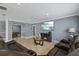 Open living area with leather seating, large TV, and view into game room at 6926 Williams Dr, Tampa, FL 33634
