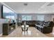 Spacious living room with leather sectional sofa and large TV at 6926 Williams Dr, Tampa, FL 33634