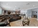 Living room with sectional sofa, coffee table, and view into dining area at 6926 Williams Dr, Tampa, FL 33634