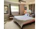Bedroom with carpet, large window, mirror, and neutral color scheme at 6951 S Shore S Dr, South Pasadena, FL 33707