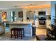 Modern kitchen featuring stainless steel appliances, granite counters, and stylish island at 6951 S Shore S Dr, South Pasadena, FL 33707