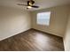 Bright bedroom with wood-look flooring and ceiling fan at 9127 Baymeadow Ct, Tampa, FL 33615