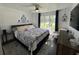 Spacious primary bedroom with large window and en-suite bathroom at 1005 Lake Avoca Pl, Tarpon Springs, FL 34689