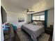 Comfortable guest bedroom with a king-size bed and teal accents at 1005 Lake Avoca Pl, Tarpon Springs, FL 34689