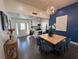 Bright dining area with a modern table and statement blue accent wall at 1005 Lake Avoca Pl, Tarpon Springs, FL 34689