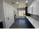 Renovated kitchen, white and navy blue cabinets, quartz countertops and patterned backsplash at 1005 Lake Avoca Pl, Tarpon Springs, FL 34689