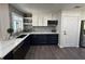 Updated kitchen featuring white and navy blue cabinets, quartz countertops and patterned tile at 1005 Lake Avoca Pl, Tarpon Springs, FL 34689