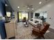 Bright living room features a comfy sofa, armchairs, and a large TV at 1005 Lake Avoca Pl, Tarpon Springs, FL 34689
