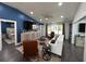 Open concept living room with hardwood floors, white sofa, and blue accent wall at 1005 Lake Avoca Pl, Tarpon Springs, FL 34689