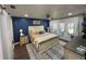 Spacious main bedroom with a king-size bed and access to a balcony at 1005 Lake Avoca Pl, Tarpon Springs, FL 34689