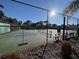 Well-maintained tennis courts with surrounding fencing at 1005 Lake Avoca Pl, Tarpon Springs, FL 34689