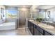 Spa-like bathroom with soaking tub, walk-in shower, and double vanity at 10609 Bridgegate Heights Loop, San Antonio, FL 33576