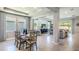 Casual dining area with a rustic table, chairs, and access to the living room at 10609 Bridgegate Heights Loop, San Antonio, FL 33576