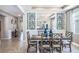 Bright dining room with farmhouse table and statement wallpaper at 10609 Bridgegate Heights Loop, San Antonio, FL 33576