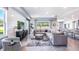 Open concept living room with sectional sofa, rug, and large windows at 10609 Bridgegate Heights Loop, San Antonio, FL 33576