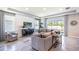 Spacious living room with a sectional sofa, large TV, and plenty of natural light at 10609 Bridgegate Heights Loop, San Antonio, FL 33576