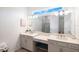 Double vanity bathroom with quartz countertops and a large mirror at 11312 Gallatin Trl, Parrish, FL 34219