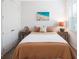 Bedroom with tan bedding and beach art at 11312 Gallatin Trl, Parrish, FL 34219
