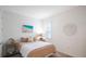 Bedroom with tan bedding and beach art at 11312 Gallatin Trl, Parrish, FL 34219
