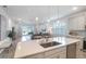 Modern kitchen with island, white cabinets, and stainless steel appliances at 11312 Gallatin Trl, Parrish, FL 34219