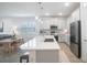 Open concept kitchen with white cabinets and a large island at 11312 Gallatin Trl, Parrish, FL 34219