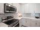 Kitchen corner with stainless steel range and white cabinets at 11312 Gallatin Trl, Parrish, FL 34219