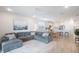 Open living room and kitchen with gray sectional sofa and kitchen island at 11312 Gallatin Trl, Parrish, FL 34219