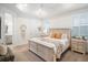 Main bedroom with a king-size bed, and access to the ensuite bathroom at 11312 Gallatin Trl, Parrish, FL 34219