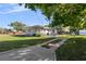 House backyard with grassy lawn, fenced pool, and driveway at 1602 30Th W St, Bradenton, FL 34205