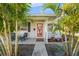 Inviting front porch with red door and comfortable seating at 1602 30Th W St, Bradenton, FL 34205