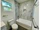 Clean bathroom with bathtub and grey marble tile at 16417 Lake Byrd Dr, Tampa, FL 33618