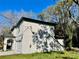 Two-story house with gray siding, a white garage door, and a landscaped yard at 16417 Lake Byrd Dr, Tampa, FL 33618