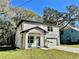 Two-story house with gray siding, a white garage door, and a landscaped yard at 16417 Lake Byrd Dr, Tampa, FL 33618