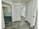 Bright hallway with grey laminate flooring and linen closet at 16417 Lake Byrd Dr, Tampa, FL 33618